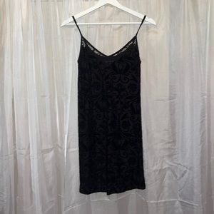 Black velvet patterned spaghetti strap dress with lace detail at top.